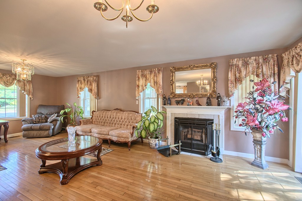 86 Acropolis Road Lowell, MA 01854 - Photo 7 of 30 a living room with furniture and a fireplace