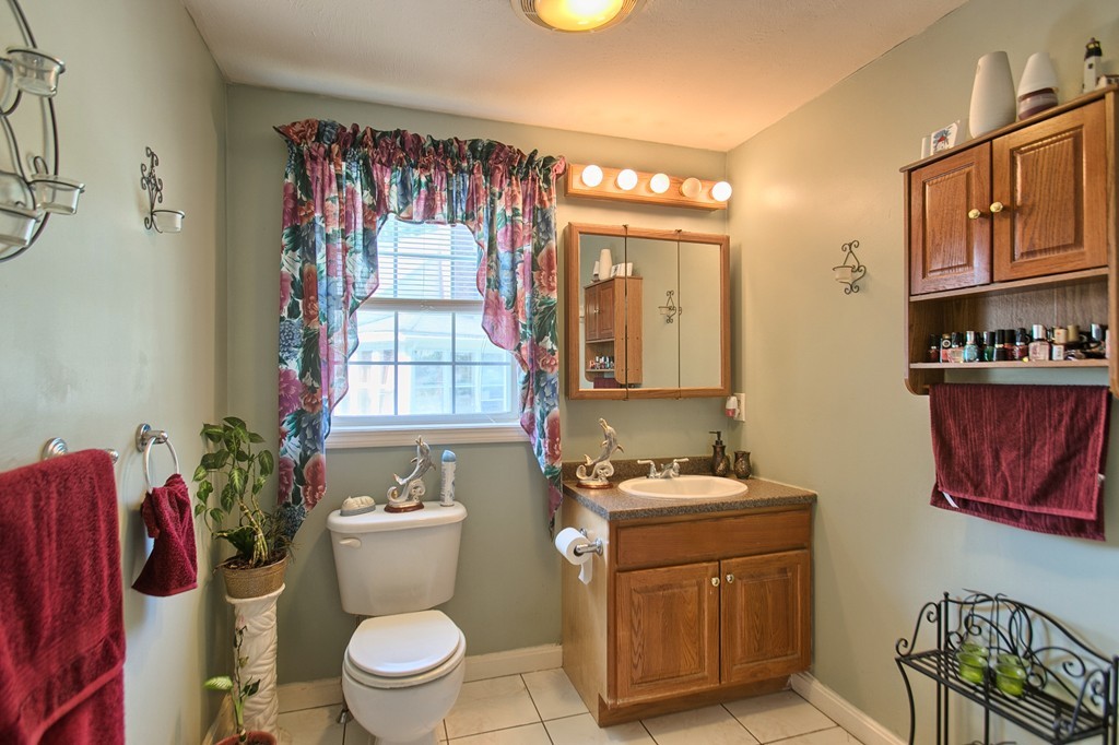 86 Acropolis Road Lowell, MA 01854 - Photo 9 of 30 a bathroom with a toilet a sink and a shower