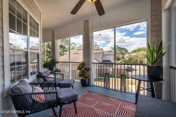 a living room with furniture tv and window