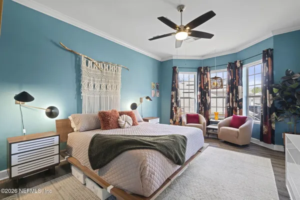 a bedroom with a bed and a chandelier