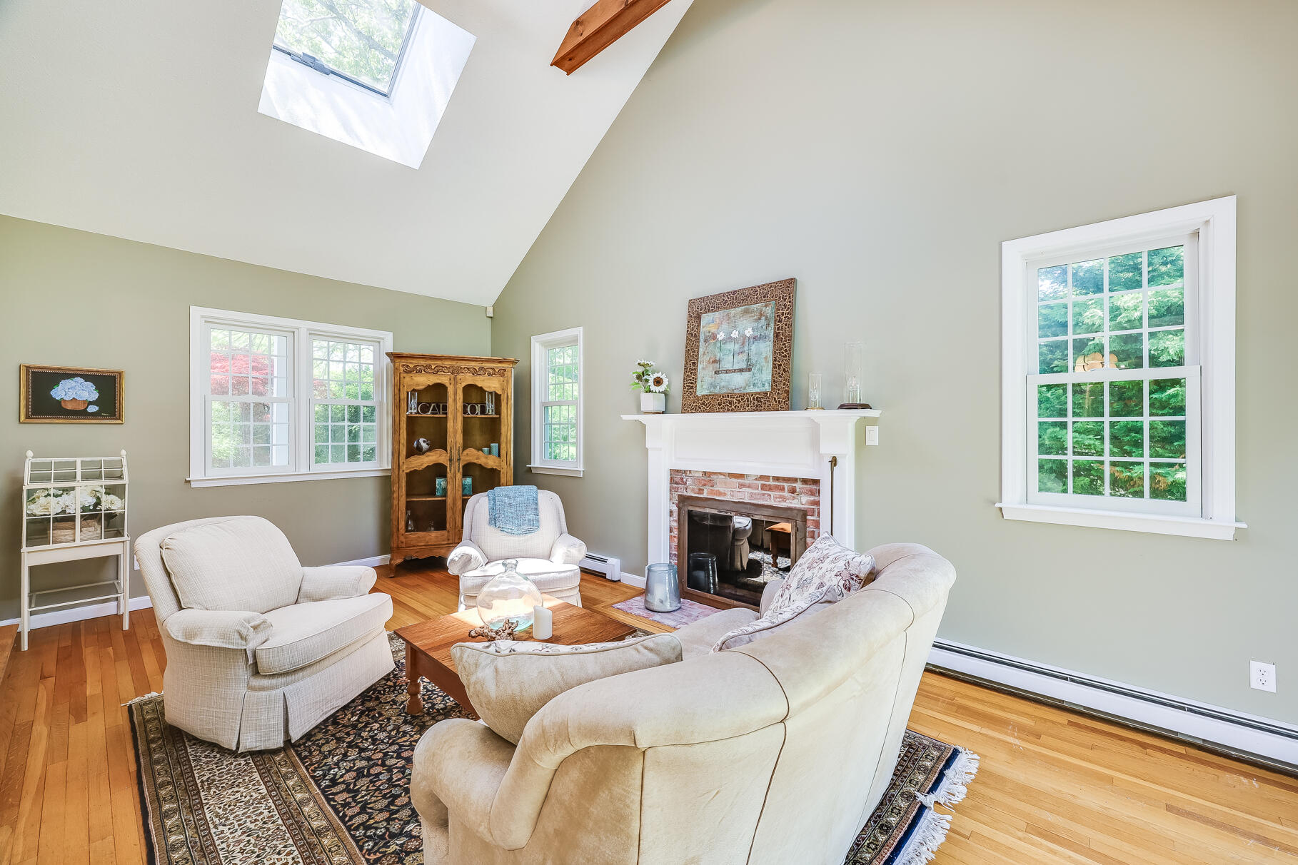 28 Sand Bar Lane Brewster, MA 02631 - Photo 13 of 74 a living room with furniture a flat screen tv and a fireplace