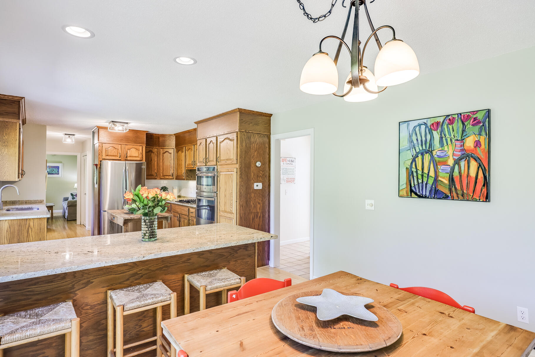 28 Sand Bar Lane Brewster, MA 02631 - Photo 17 of 74 a bathroom with a sink a chandelier and a view of living room