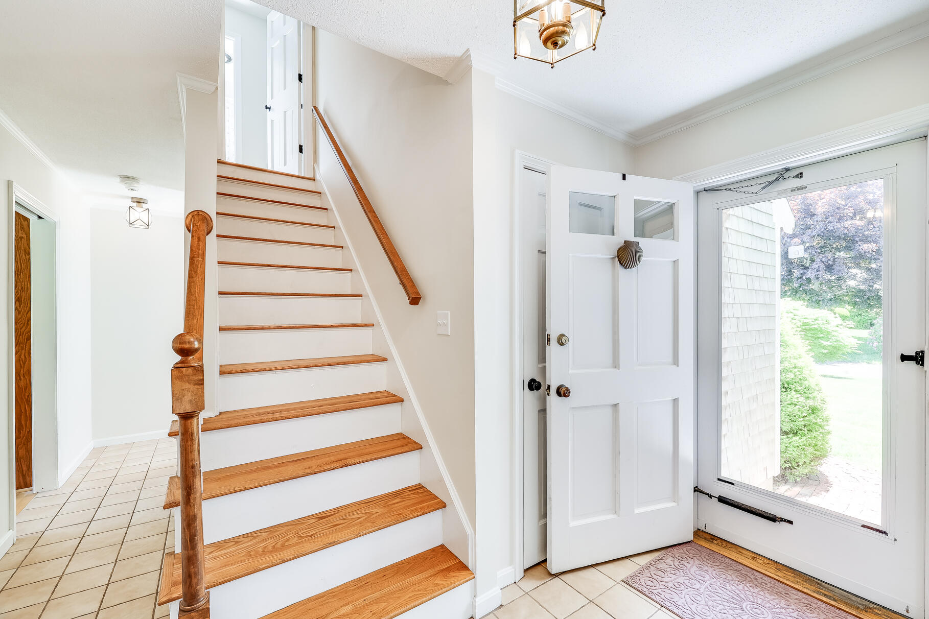 28 Sand Bar Lane Brewster, MA 02631 - Photo 33 of 74 a view of a front door with wooden floor and stairs