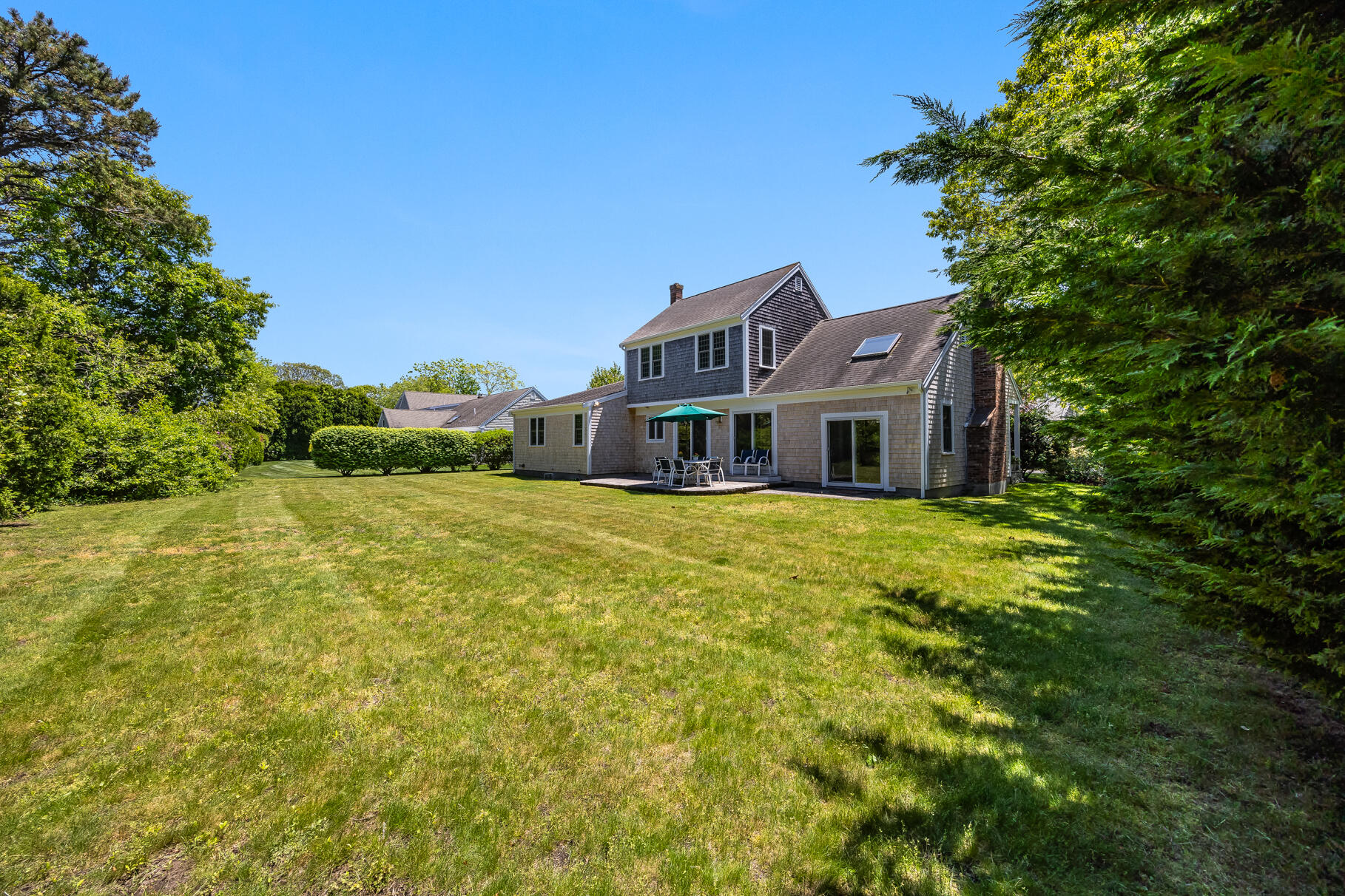 28 Sand Bar Lane Brewster, MA 02631 - Photo 42 of 74 a front view of a house with a garden
