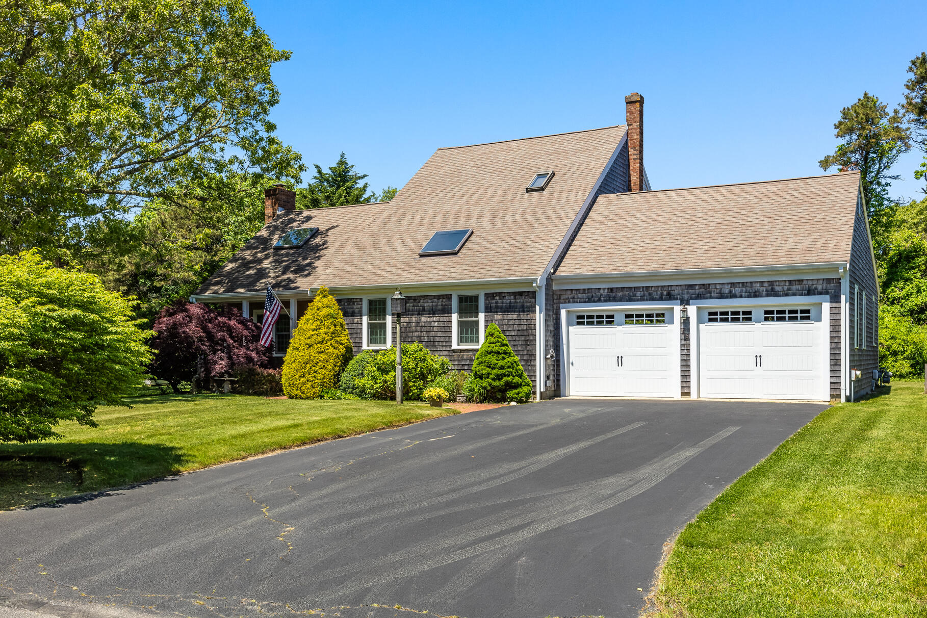 28 Sand Bar Lane Brewster, MA 02631 - Photo 44 of 74 a front view of a house with a garden and yard