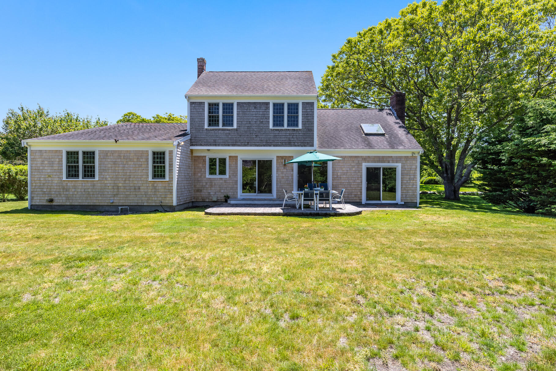 28 Sand Bar Lane Brewster, MA 02631 - Photo 45 of 74 a front view of a house with swimming pool and porch