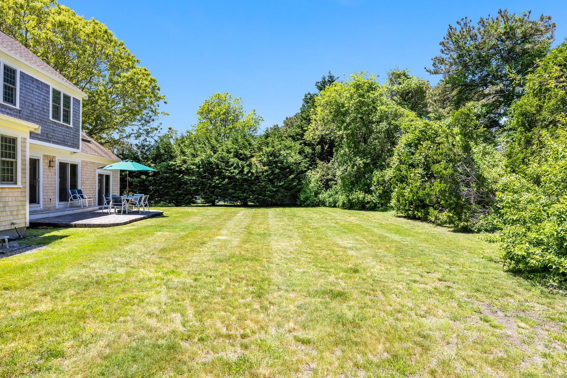 28 Sand Bar Lane Brewster, MA 02631 - Photo 46 of 74 a view of a swimming pool with an outdoor space and seating area