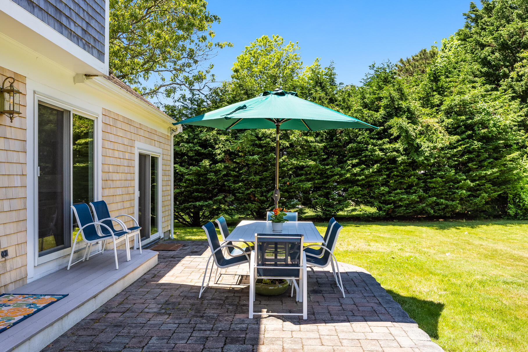 28 Sand Bar Lane Brewster, MA 02631 - Photo 48 of 74 a patio with glass top table and chairs
