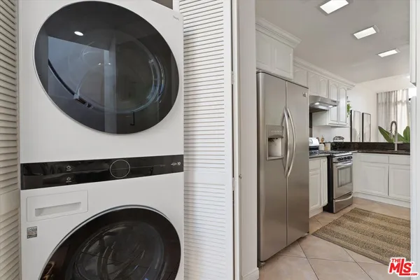 a view of a hallway with washer and dryer