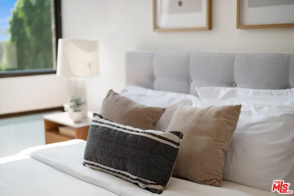 a bedroom with a bed and a couch