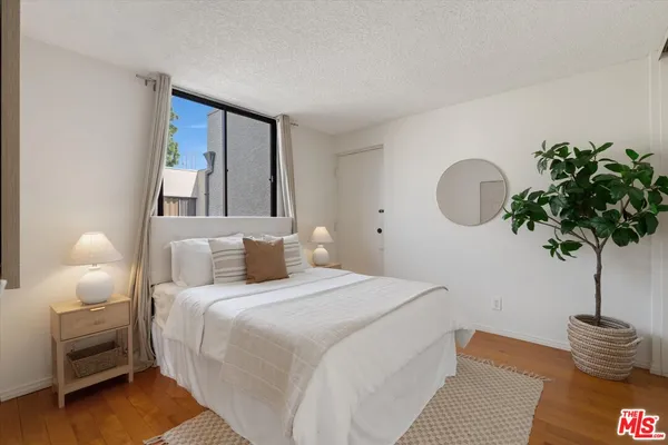 a bedroom with a bed and a window with outer view