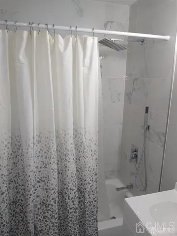 a bathroom with a shower and a tub