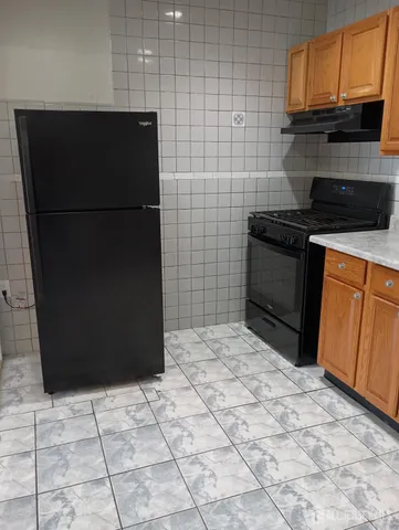 a kitchen with a refrigerator and a stove