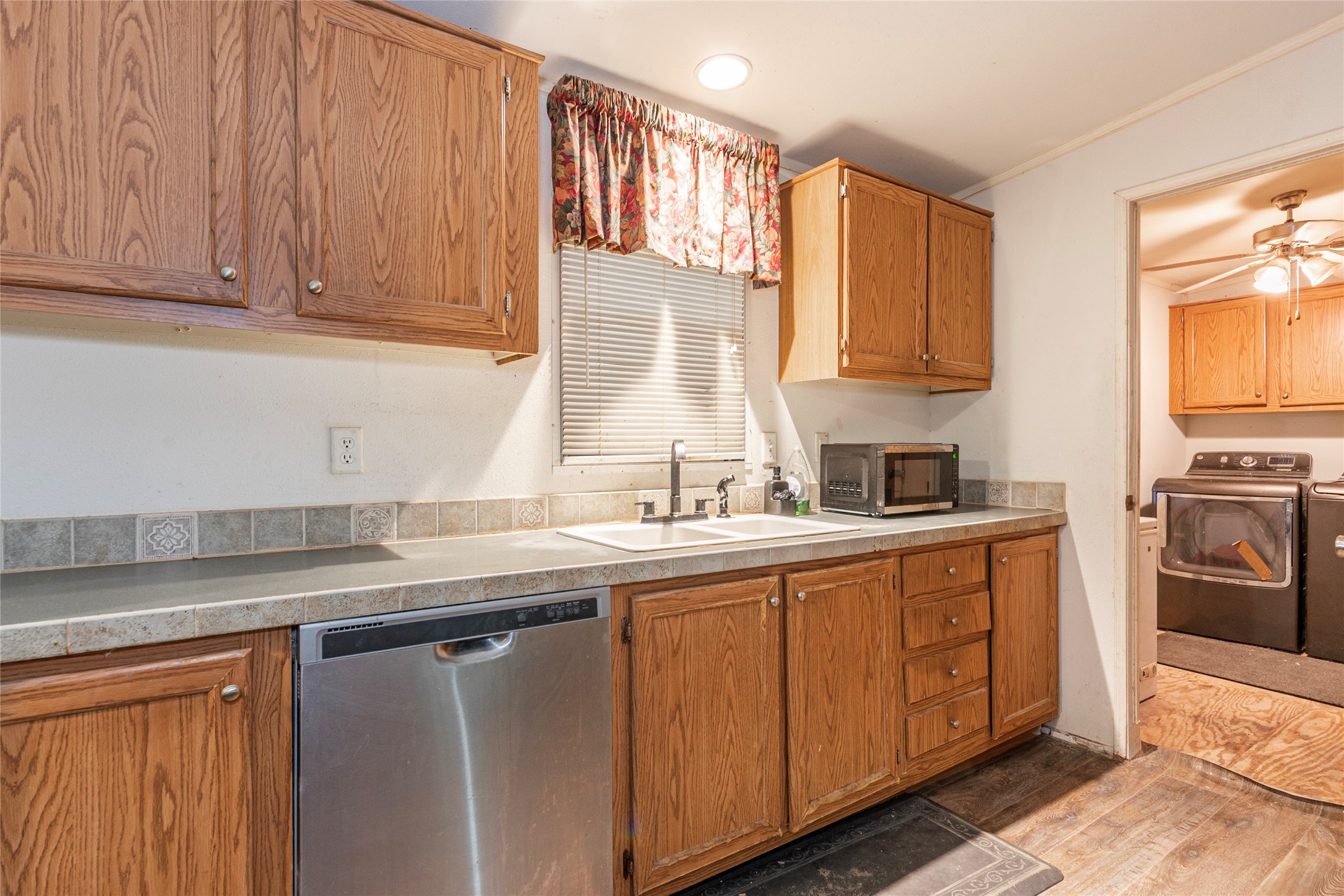 4624 6th Street Bacliff, TX 77518 - Photo 14 of 36 a kitchen with stainless steel appliances granite countertop a sink a stove and a refrigerator