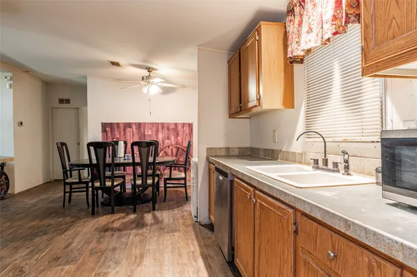 a kitchen with a table chairs sink and cabinets