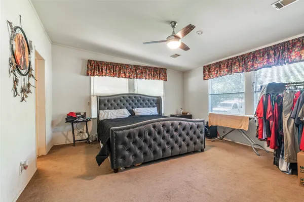 a bedroom with furniture and a window