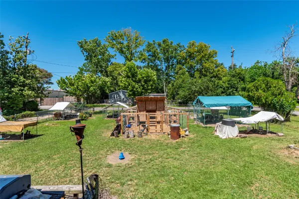 a view of a chair and table on the garden
