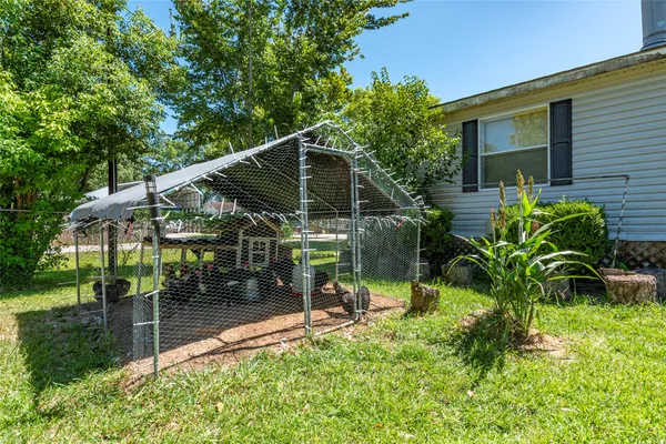 a view of house with a yard