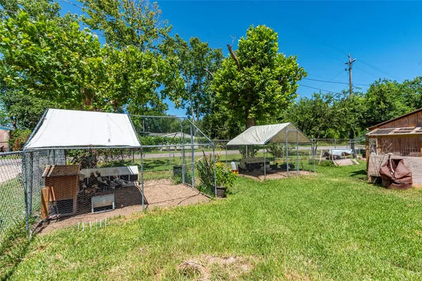 a view of a house with backyard sitting area and garden