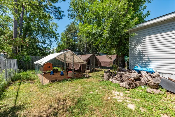 a backyard of a house with barbeque oven and outdoor seating