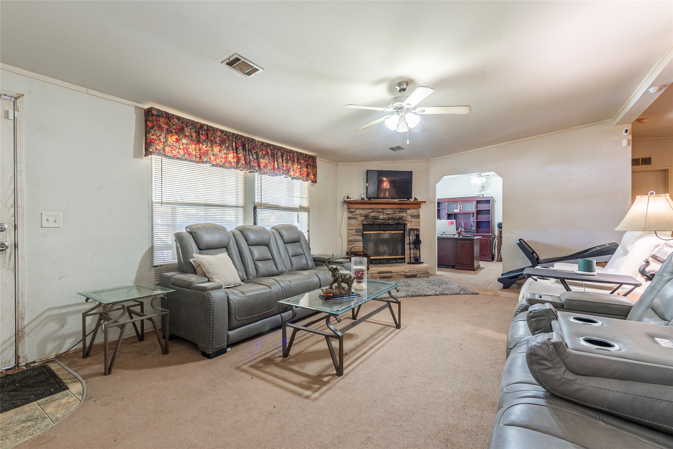 4624 6th Street Bacliff, TX 77518 - Photo 5 of 36 a living room with furniture a large window and a flat screen tv