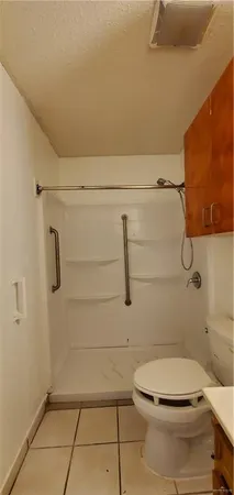 a bathroom with a toilet and a shower
