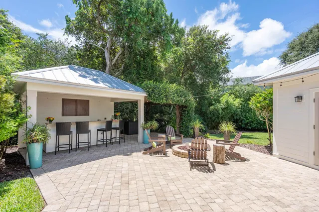 a living room with furniture a flat screen tv and a sink