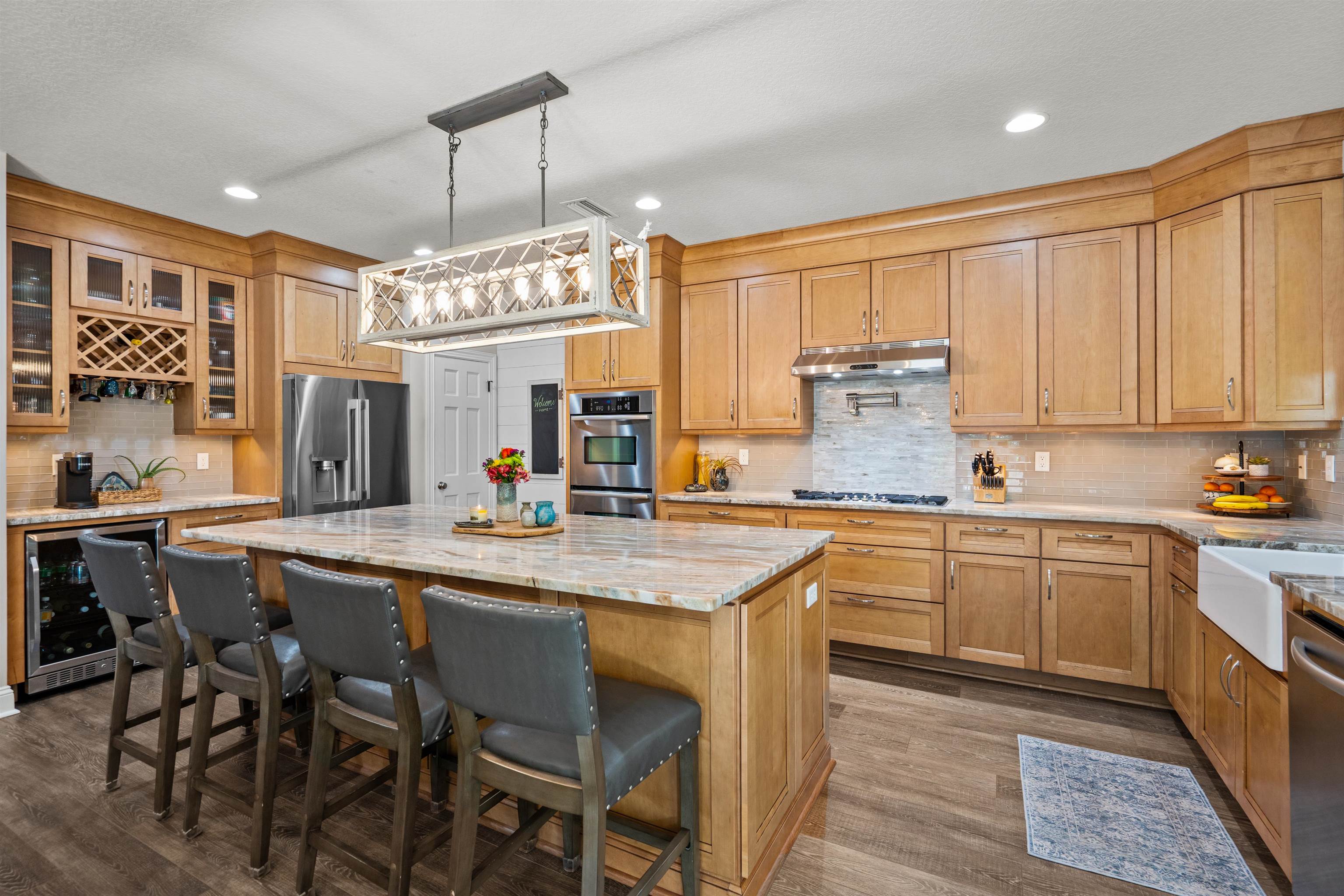 912 Sandy Beach Circle St. Augustine, FL 32080 - Photo 17 of 71 Kitchen featuring backsplash, beverage cooler, dark wood-style floors, a kitchen island, and recessed lighting