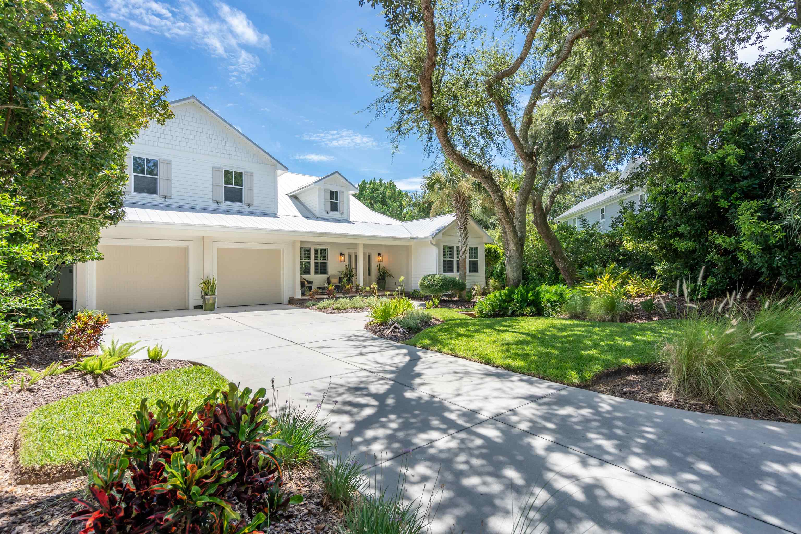 912 Sandy Beach Circle St. Augustine, FL 32080 - Photo 25 of 71 a front view of a house with garden and porch