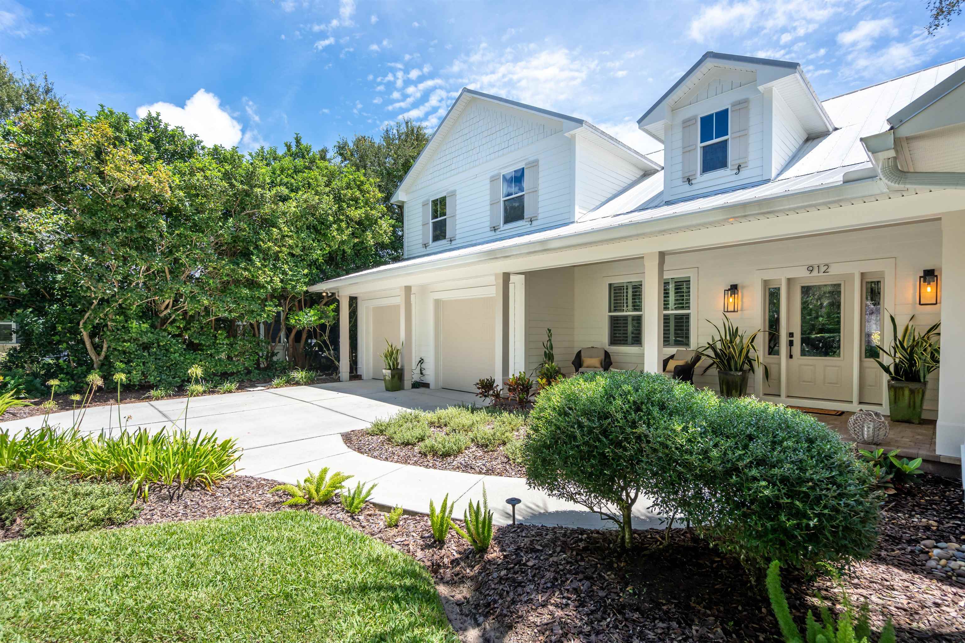 912 Sandy Beach Circle St. Augustine, FL 32080 - Photo 26 of 71 View of front of house featuring driveway, an attached garage, and a porch