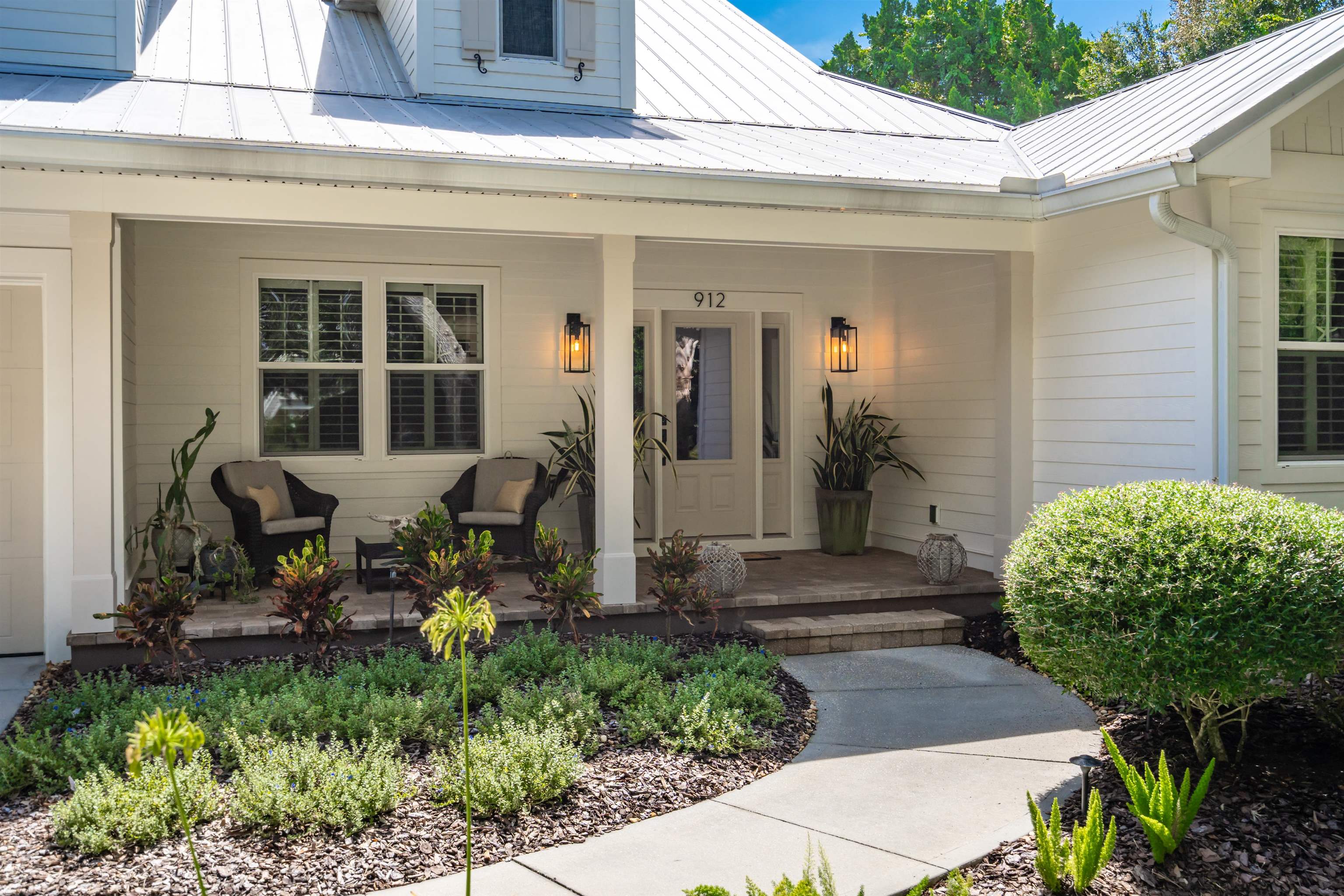 912 Sandy Beach Circle St. Augustine, FL 32080 - Photo 27 of 71 a view of a house with potted plants and a bench