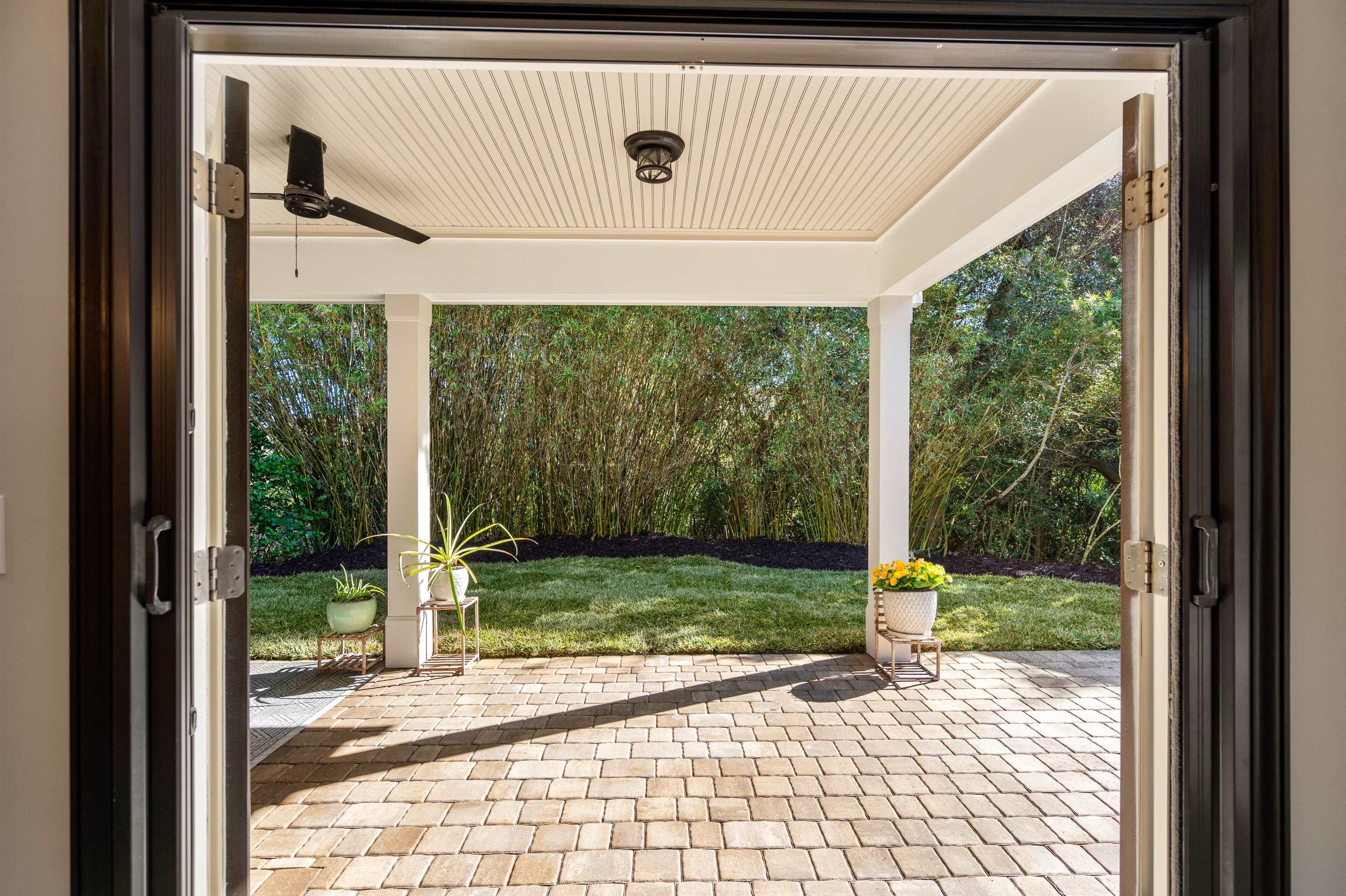 912 Sandy Beach Circle St. Augustine, FL 32080 - Photo 31 of 71 View of patio featuring a ceiling fan and view of scattered trees
