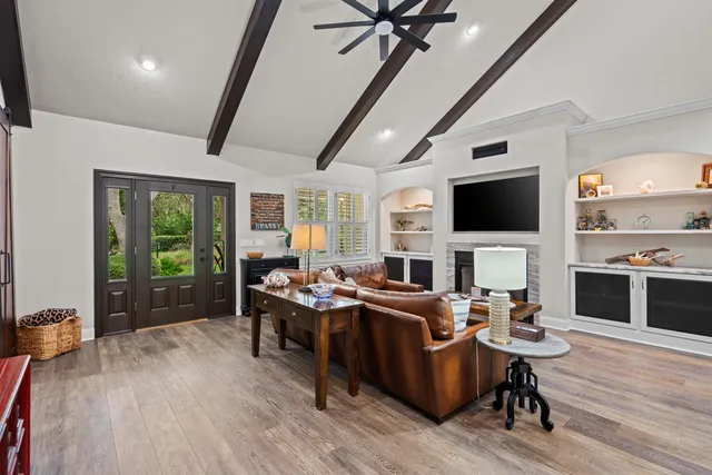 a living room with furniture a ceiling fan and a rug