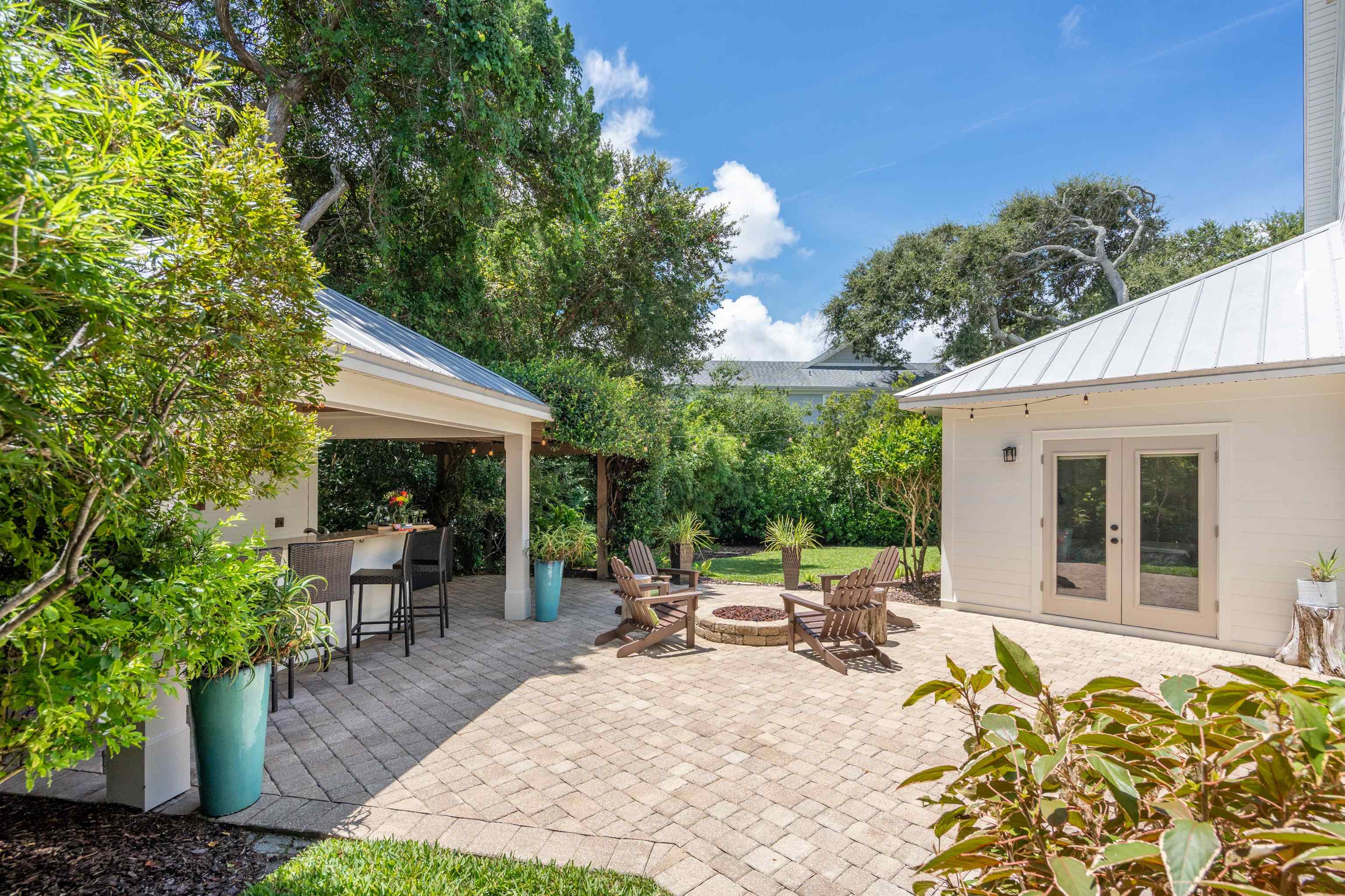 912 Sandy Beach Circle St. Augustine, FL 32080 - Photo 32 of 71 a view of a patio with table and chairs under an umbrella