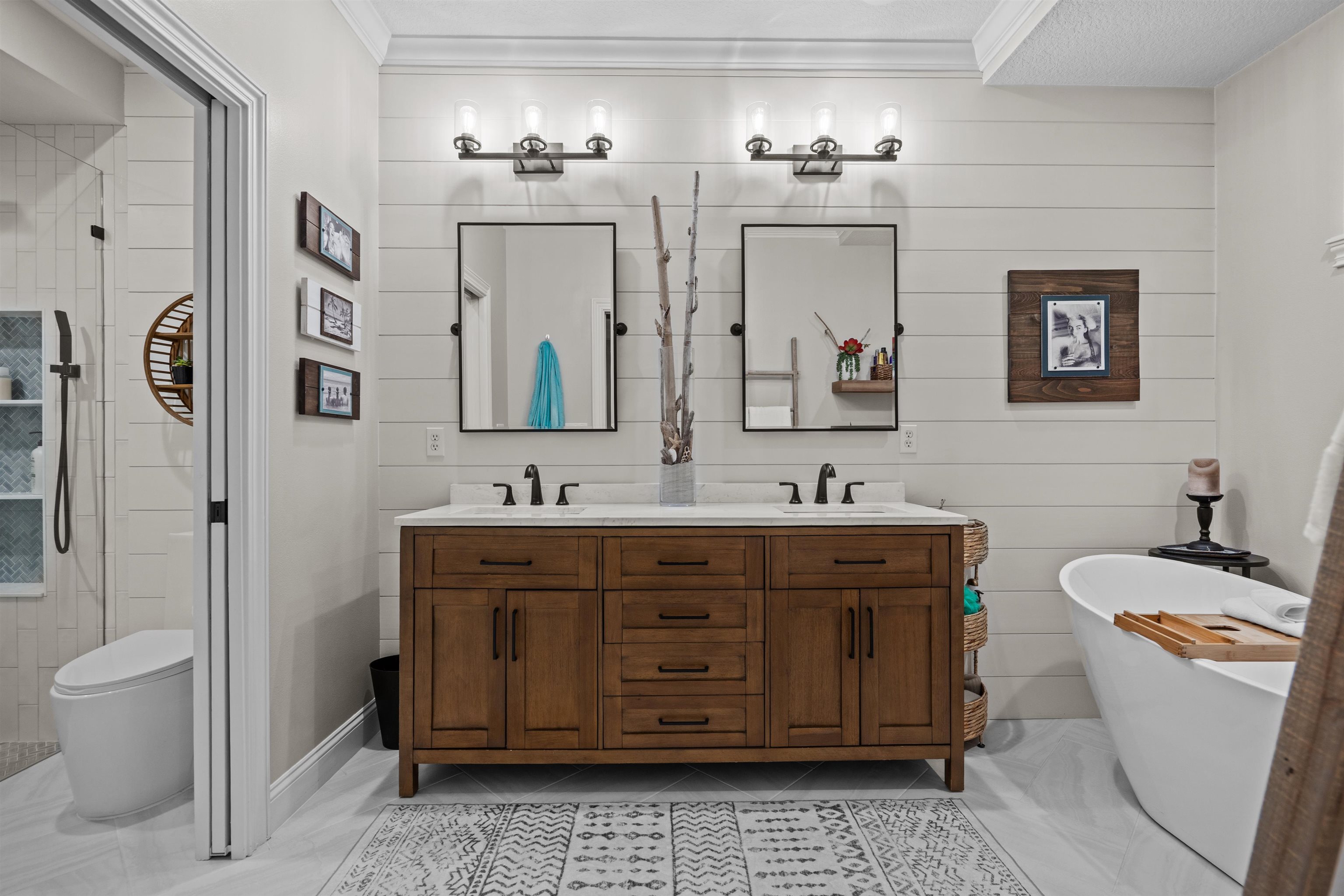 912 Sandy Beach Circle St. Augustine, FL 32080 - Photo 45 of 71 Bathroom with double vanity, a shower stall, a freestanding bath, crown molding, and wooden walls