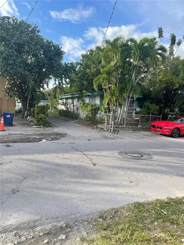 a front view of a house with cars