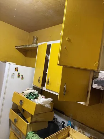 a bathroom with a granite countertop sink and white cabinets
