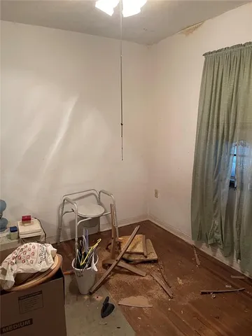 a living room with furniture a rug and white walls