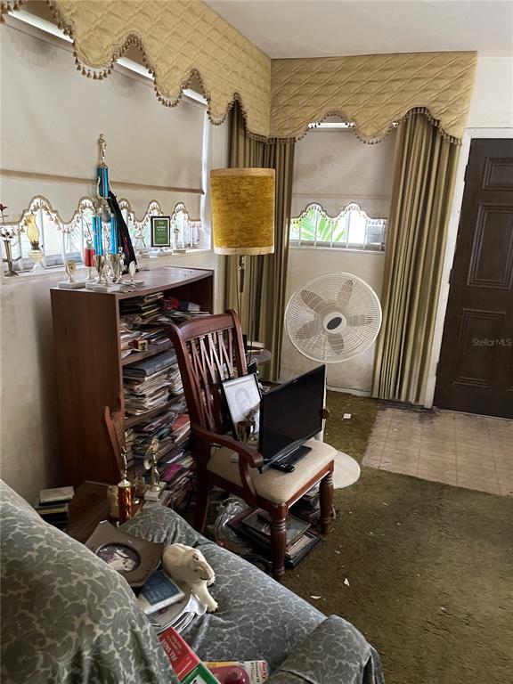 1510 Northwest 70th Street Miami, FL 33147 - Photo 40 of 58 a living room with furniture a rug and white walls