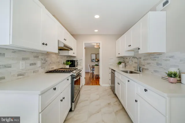 a living room with furniture a fireplace and a chandelier