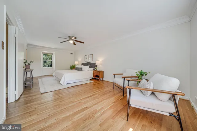 a bedroom with a bed a dresser and chair