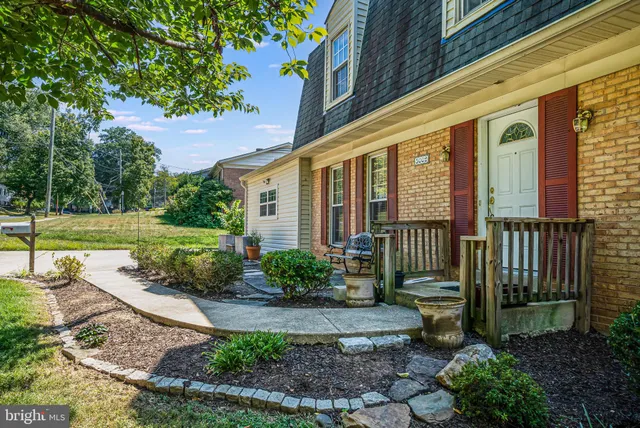 a view of a house with a yard and sitting area