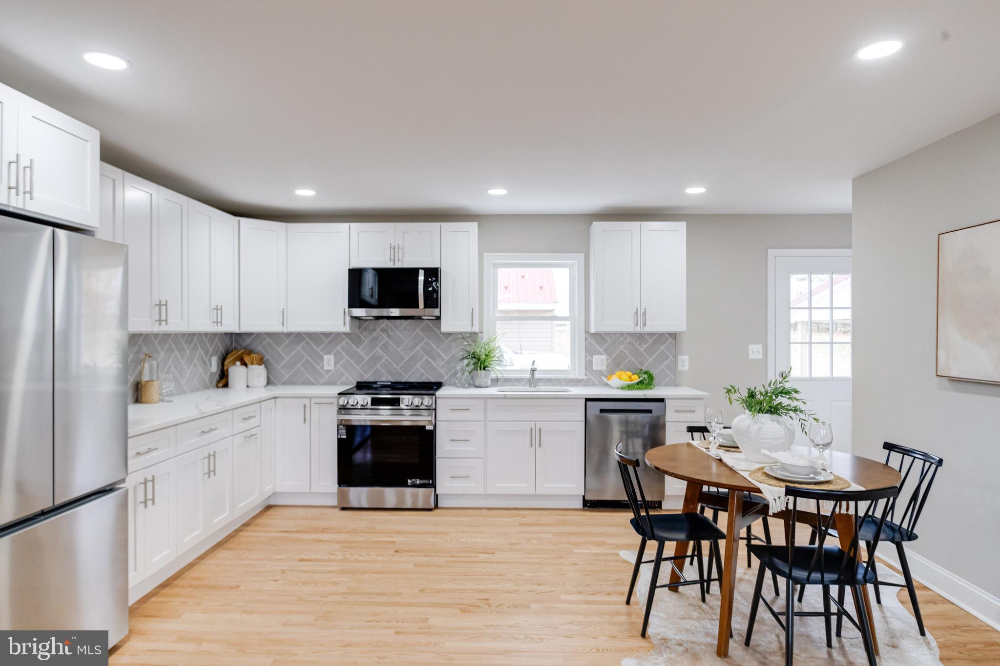 733 Reckord Road Fallston, MD 21047 - Photo 11 of 71 a kitchen with a white cabinets and chairs