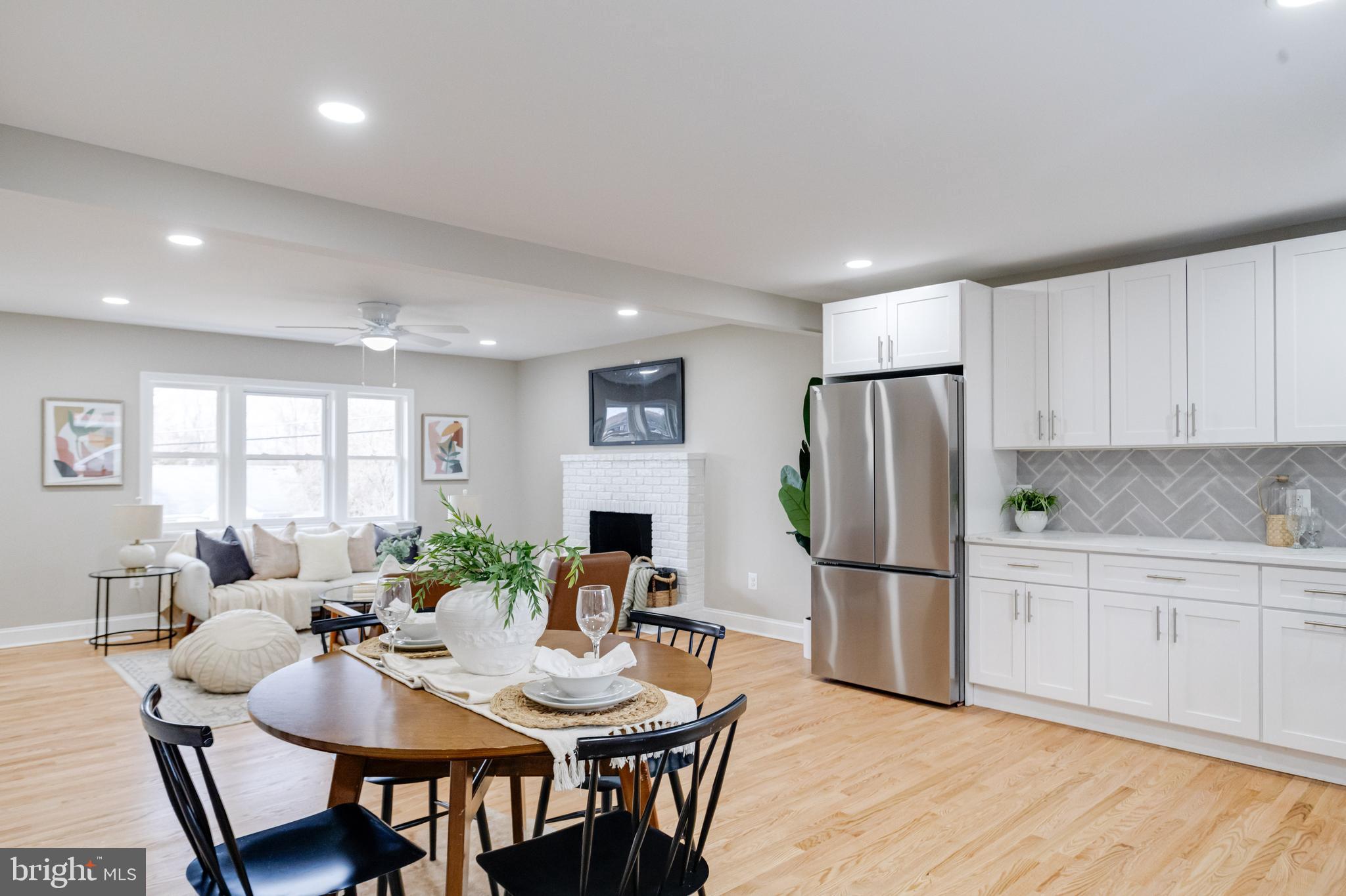 733 Reckord Road Fallston, MD 21047 - Photo 14 of 71 a kitchen with stainless steel appliances granite countertop a refrigerator a sink dishwasher a dining table and chairs with wooden floor