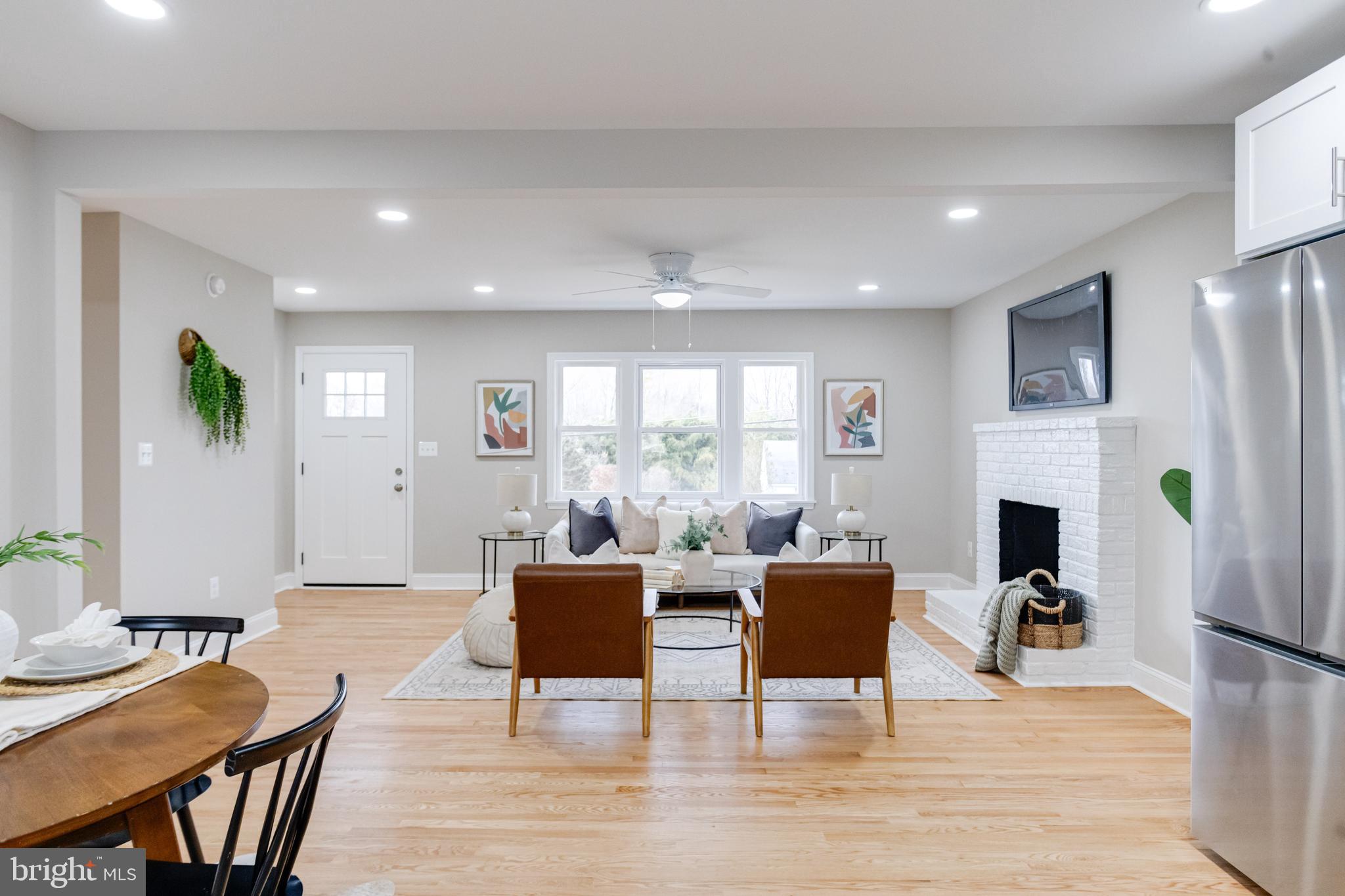 733 Reckord Road Fallston, MD 21047 - Photo 15 of 71 a living room with furniture a fireplace and a dining table with wooden floor