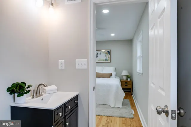 a bed sitting in a bedroom next to a window