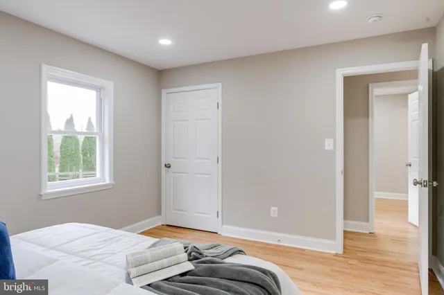 a bedroom with a bed and a painting on the wall