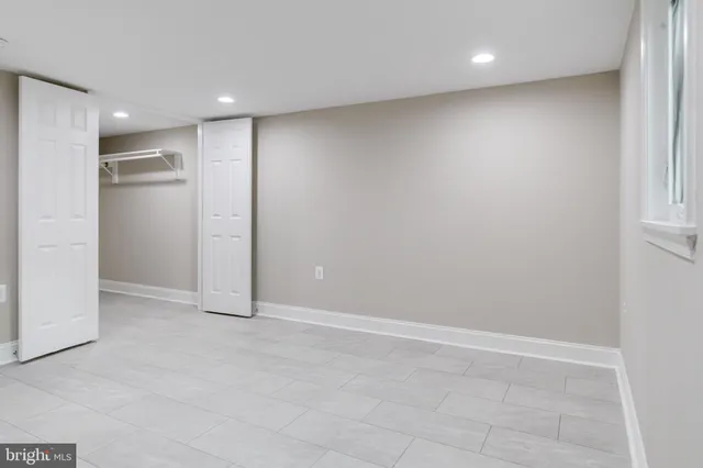 a view of a hallway with wooden shelves