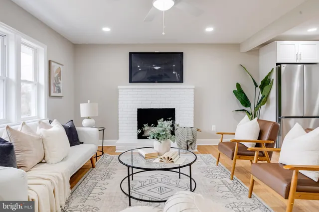 a living room with furniture and a fireplace