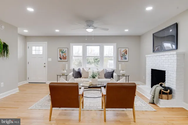 a living room with fireplace furniture and a flat screen tv